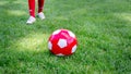 Red soccer ball on a green field Royalty Free Stock Photo