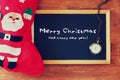 Red sock and blackboard with merry christams greeting. christmas card concept.