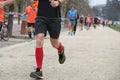 Red-Socked Athlete s Sprint in the Park During Footrace Competition