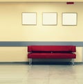 Style minimalism. Red Sofa, interior design, office. Empty waiting room with a modern red sofa in front of the door and three empt Royalty Free Stock Photo