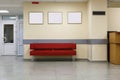 Style minimalism. Red Sofa, interior design, office. Empty waiting room with a modern red sofa in front of the door and Royalty Free Stock Photo