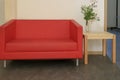 Red sofa and small wooden table Royalty Free Stock Photo