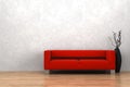 Red sofa and vase in front of white wall Royalty Free Stock Photo