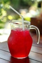 Red Soft drink with ice on blurred bokeh background. Royalty Free Stock Photo