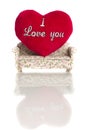 Red soft heart with sign I love you on small sofa isolated on white background.