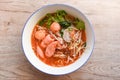 Red soup noodle pork with red roasted pork and bean sprout vegetable in soup bowl on wooden table, top view Thai and China Asian Royalty Free Stock Photo