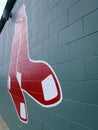Red Sox historic baseball logo painted on a green brick wall