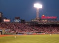 Red Sox Outfielders stand in position for upcoming play with crowded bleachers and billboard ads Royalty Free Stock Photo