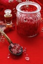 Red spa set: jar of sea salt, bar of soap and bottle of essential oil Royalty Free Stock Photo