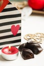 Red sparkling lit candle and dark chocolate Royalty Free Stock Photo