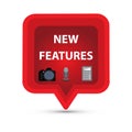 Red speech bubble with a camera, a microphone, a calculator and the text new features Royalty Free Stock Photo