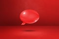 Red speech bubble on concrete wall background Royalty Free Stock Photo