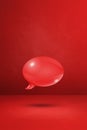 Red speech bubble on concrete wall vertical background Royalty Free Stock Photo