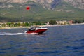Red speedboat with red parashute
