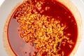 Red Spicy Noodle Soup in White Bowl, Hot Chili Pepper Ramen Texture Closeup Royalty Free Stock Photo