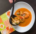 Red spicy prawn soup on the wooden plate Royalty Free Stock Photo