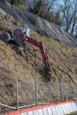 Red spider type excavator in operation on a steep slope. Specialized equipment. Drilling. The strengthening of the slope Royalty Free Stock Photo