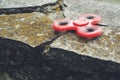 Red spinner fidget toy spinning on stones background. Royalty Free Stock Photo