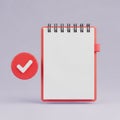 Red Spiral Notebook with Blank White Page and Red Checkmark Circle on Purple Background notepad Royalty Free Stock Photo
