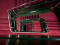 Red spiral staircase with green railing going down Royalty Free Stock Photo