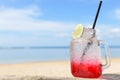 Red spirit drink lemon soda cocktail on beach