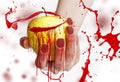 Red splashes on yellow apple in a female hand with long red nails isolated on white background Royalty Free Stock Photo