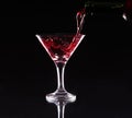 Red splashing cocktail on black Royalty Free Stock Photo