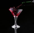 Red splashing cocktail on black Royalty Free Stock Photo