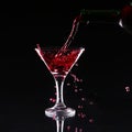 Red splashing cocktail on black Royalty Free Stock Photo