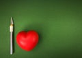 Spongy red heart and scalpel Royalty Free Stock Photo