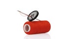 Red spool, black button and needle