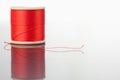 Red spool of thread on a table Royalty Free Stock Photo