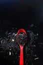 Red spoon on a handful of tea Royalty Free Stock Photo