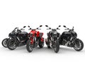 Red sports bike stands out amongst black ones