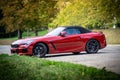 Red sports BMW Z4 convertible in the parking lot outside