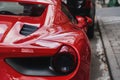 A red sports car is parked on an ordinary street