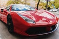 A red sports car is parked on an ordinary street