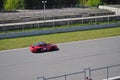 A red sports car Porsche 911 rides on a racing circuit. Fast driving on asphalt track. Royalty Free Stock Photo