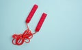 Red sports jump rope on a blue background, top view