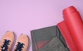 Red sports mat pair of pink sneakers on a purple background Royalty Free Stock Photo