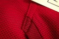 Red sportswear closeup top view. seam and juncture. breathable knitwear. clothing details macro