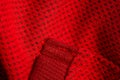 Red sportswear closeup top view. seam and juncture. breathable knitwear. clothing details macro