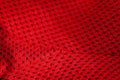 Red sportswear closeup top view. seam and juncture. breathable knitwear. clothing details macro