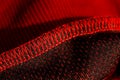 Red sportswear closeup top view. seam and juncture inside out. breathable knitwear. clothing details macro Royalty Free Stock Photo