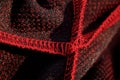 Red sportswear closeup top view. seam and juncture inside out. breathable knitwear. clothing details macro Royalty Free Stock Photo