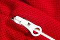 Red sportswear closeup top view. white zip line. breathable knitwear. clothing details macro Royalty Free Stock Photo