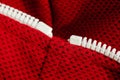 Red sportswear closeup top view. white zip line. breathable knitwear. clothing details macro