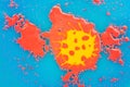 Red spots and bubbles on a blue background. The yellow pattern of the coronavirus in the red liquid. A mix of Royalty Free Stock Photo