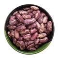 Red spotted pinto beans in round bowl isolated