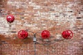 Red Sprinkler Valves against Red Brick Background Royalty Free Stock Photo